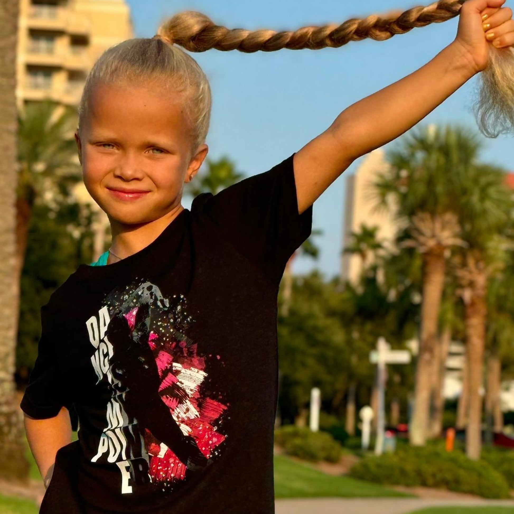 Eseniia wearing Dance is My Power T-Shirt by Eseniia in black, highlighting the inspirational dance message