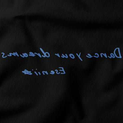 Close-up of Dance Your Dreams T-Shirt by Eseniia, showcasing the backward text design in black