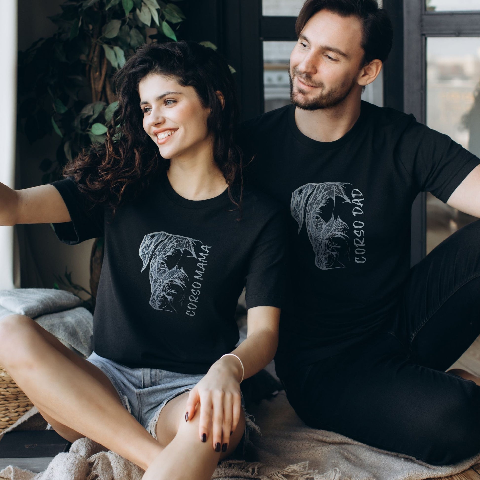 Couple wearing matching Cane Corso Mama and Cane Corso Dad shirts, showcasing the hand-drawn designs