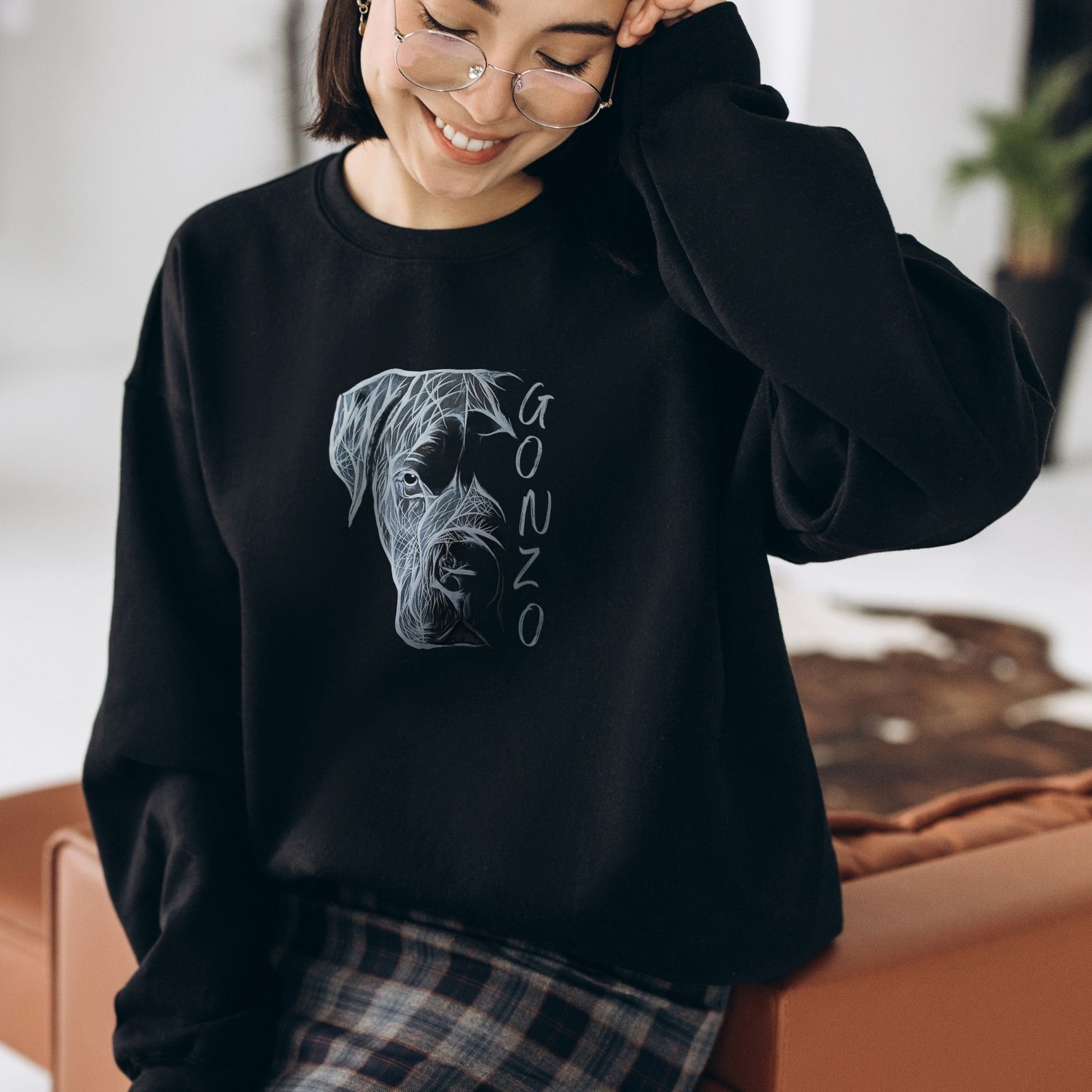 Black unisex sweatshirt with a unique hand-drawn Cane Corso graphic on a woman 